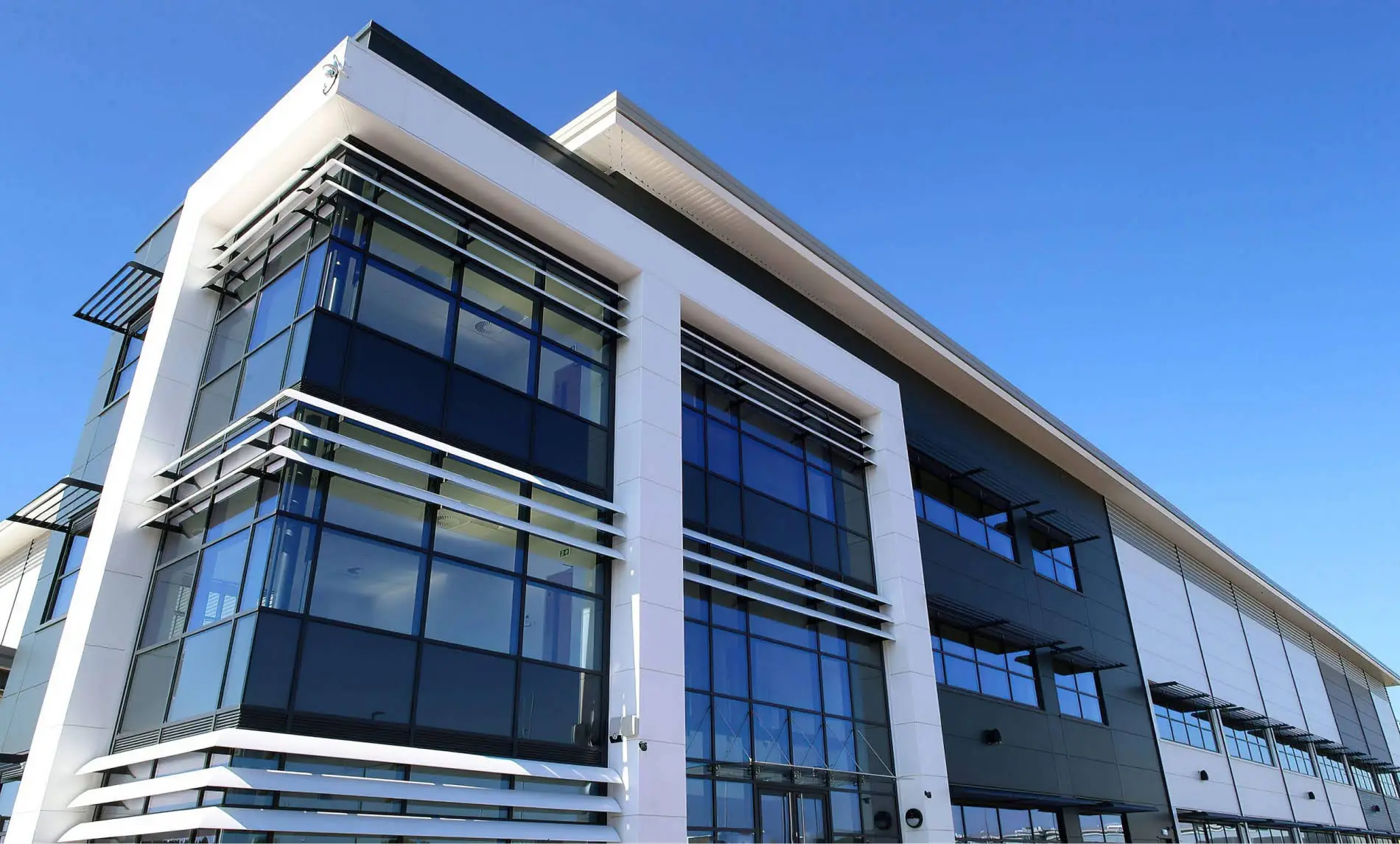 Aluminium-framed glazing and external shading on a commercial building